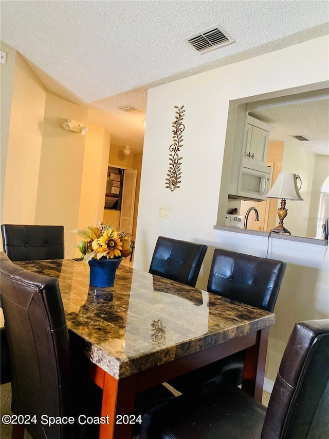 dining area with a textured ceiling