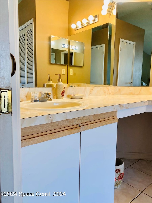 bathroom with tile patterned floors and vanity