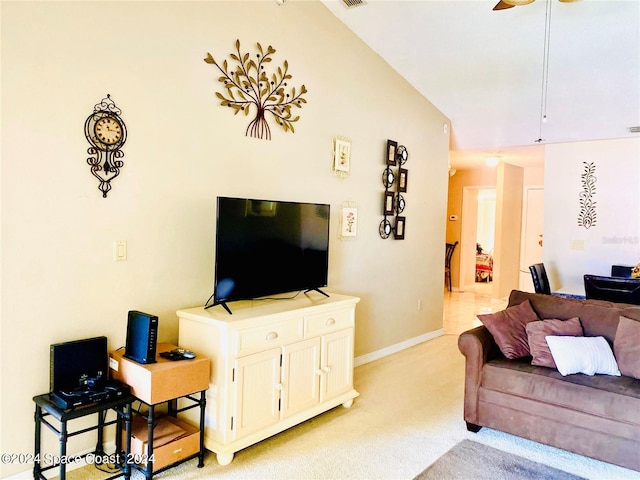 living room with ceiling fan, light carpet, and lofted ceiling