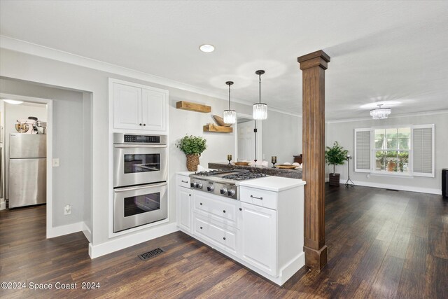 kitchen featuring white cabinetry, crown molding, stainless steel appliances, and decorative columns