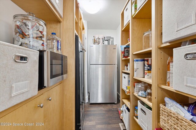 kitchen with dark hardwood / wood-style floors and stainless steel appliances