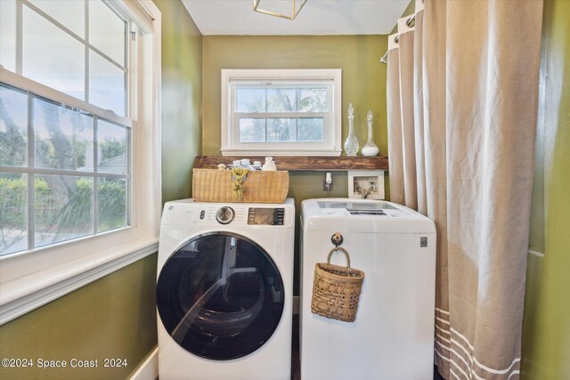 laundry area with washer and dryer and a healthy amount of sunlight