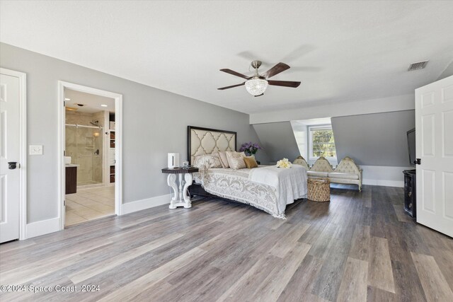 bedroom featuring ceiling fan, wood-type flooring, and ensuite bath