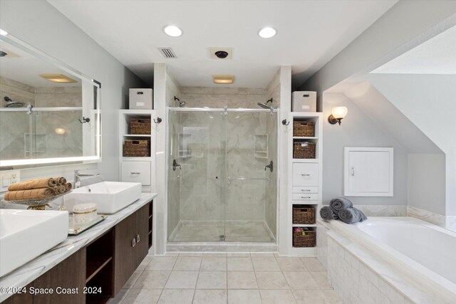 bathroom with vanity, tile patterned floors, and plus walk in shower