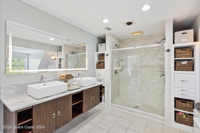 bathroom with vanity, tile patterned floors, and a shower with door