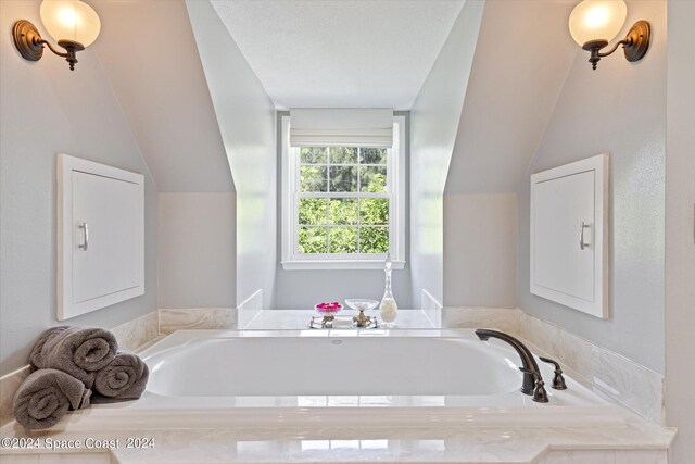 bathroom featuring vaulted ceiling