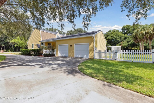 view of home's exterior with a garage and a lawn