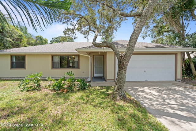 single story home featuring a front lawn and a garage