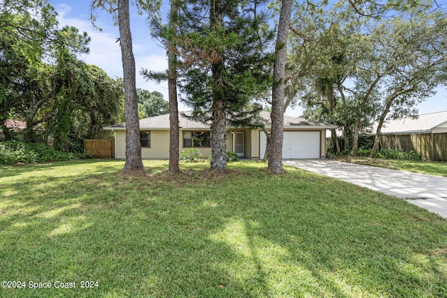 ranch-style home featuring a garage and a front yard