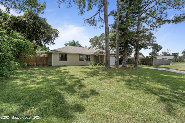 exterior space with a front yard and a garage