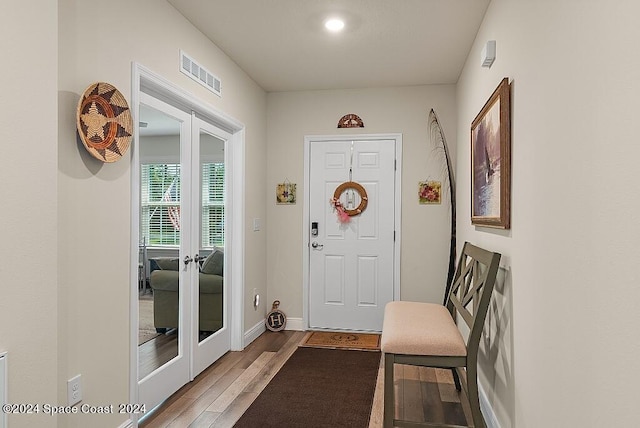 entrance foyer with hardwood / wood-style floors and french doors