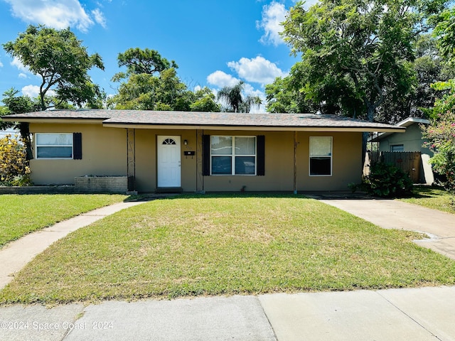 ranch-style house with a front lawn