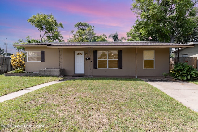 single story home with a yard