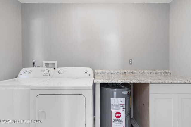 laundry area with separate washer and dryer and electric water heater