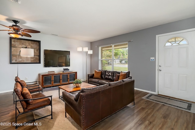 living room featuring hardwood / wood-style floors and ceiling fan