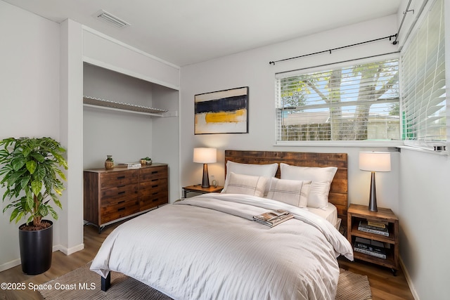 bedroom with dark hardwood / wood-style flooring