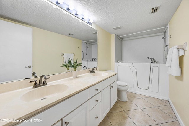 bathroom with tile patterned flooring, a sink, and visible vents