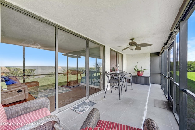 sunroom featuring ceiling fan