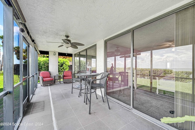 sunroom featuring ceiling fan