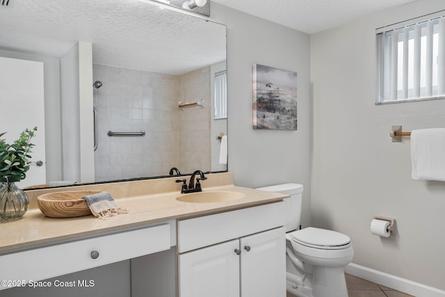 full bath with toilet, a textured ceiling, vanity, tiled shower, and tile patterned floors