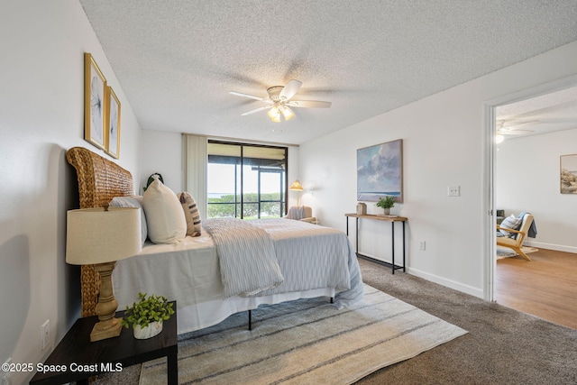 carpeted bedroom with access to exterior, a ceiling fan, baseboards, and a textured ceiling