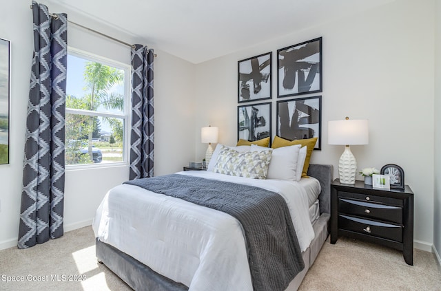 carpeted bedroom featuring multiple windows