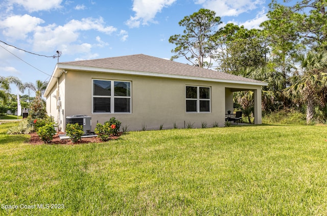 view of property exterior with central AC and a lawn