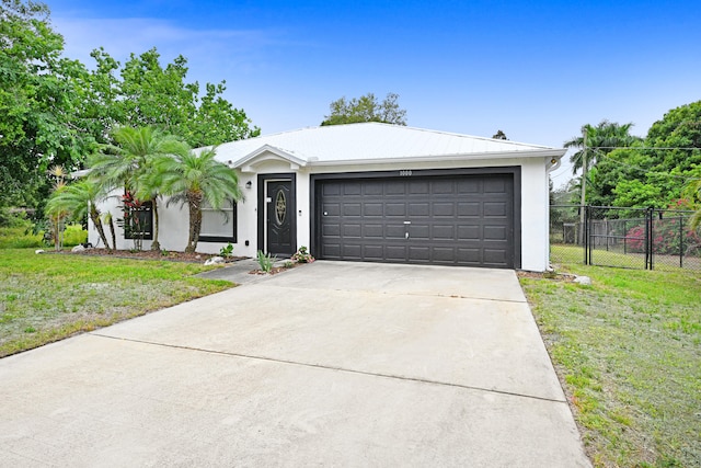 ranch-style home with a front yard and a garage