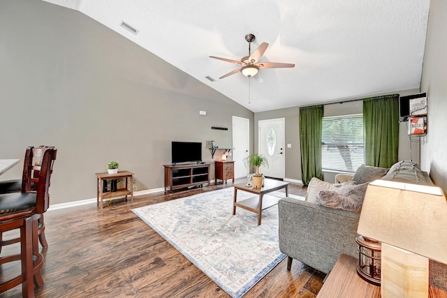 living room with ceiling fan, a textured ceiling, vaulted ceiling, and dark hardwood / wood-style flooring