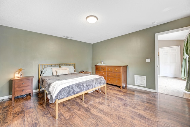 bedroom with dark hardwood / wood-style flooring