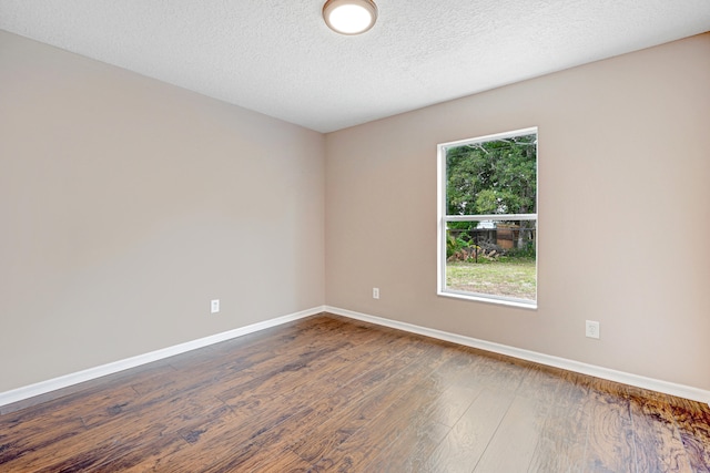 unfurnished room featuring a textured ceiling and hardwood / wood-style floors