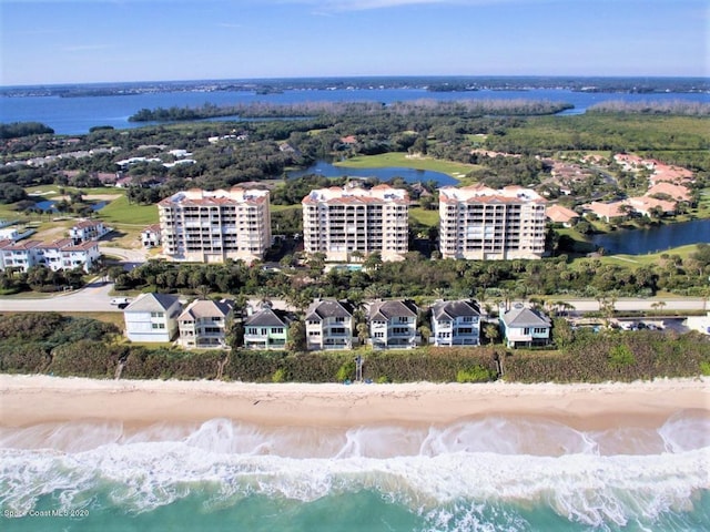 drone / aerial view featuring a water view and a beach view