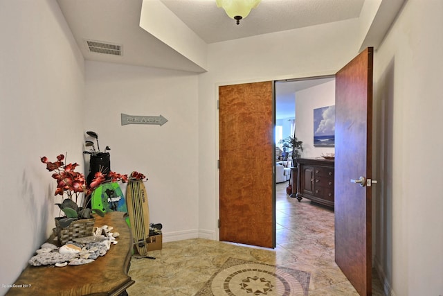 corridor featuring a textured ceiling