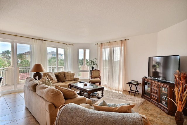 tiled living room featuring a textured ceiling