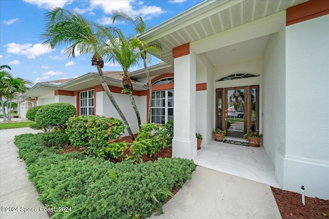 entrance to property with stucco siding