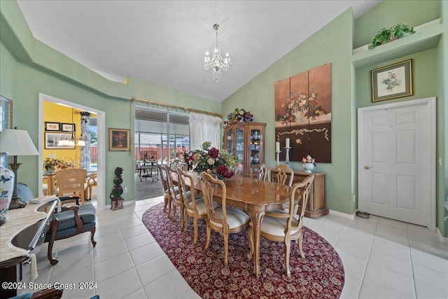 dining area with high vaulted ceiling, baseboards, an inviting chandelier, and light tile patterned floors