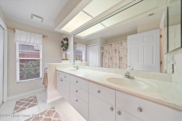 bathroom with tile patterned floors, a shower with curtain, and vanity