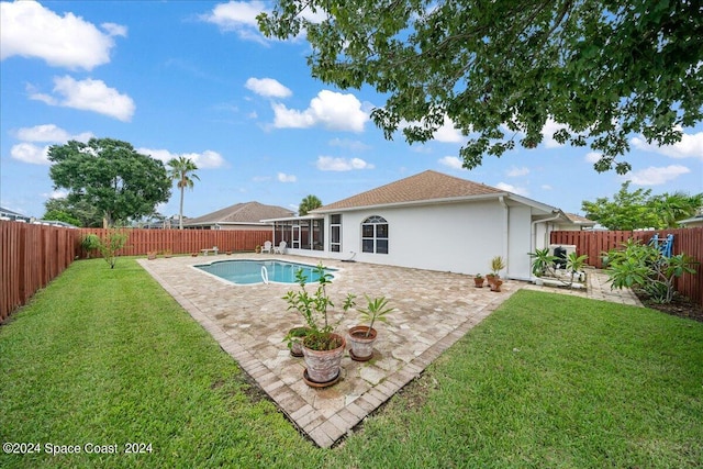 view of swimming pool with a patio and a yard