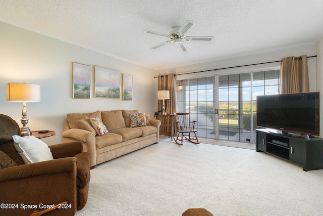 living room with ceiling fan, a textured ceiling, carpet floors, and ornamental molding