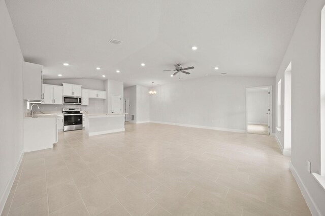 unfurnished living room with light tile patterned floors, ceiling fan, lofted ceiling, and sink