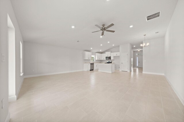 unfurnished living room featuring ceiling fan with notable chandelier, light tile patterned flooring, and lofted ceiling