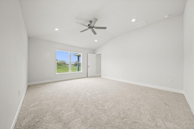 carpeted spare room featuring ceiling fan and lofted ceiling