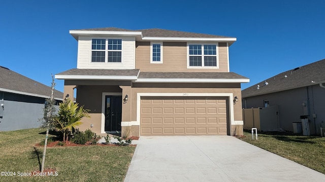 view of front of home with a garage and a front lawn