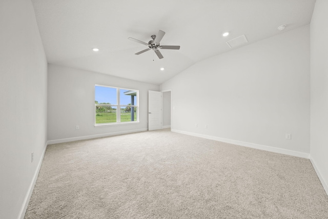 carpeted empty room with vaulted ceiling and ceiling fan