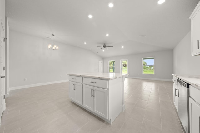 kitchen with white cabinetry, decorative light fixtures, vaulted ceiling, stainless steel dishwasher, and a kitchen island