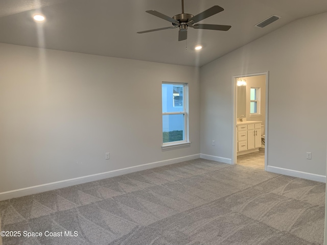 unfurnished room featuring lofted ceiling, light colored carpet, and ceiling fan