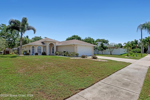 ranch-style house with a garage and a front lawn