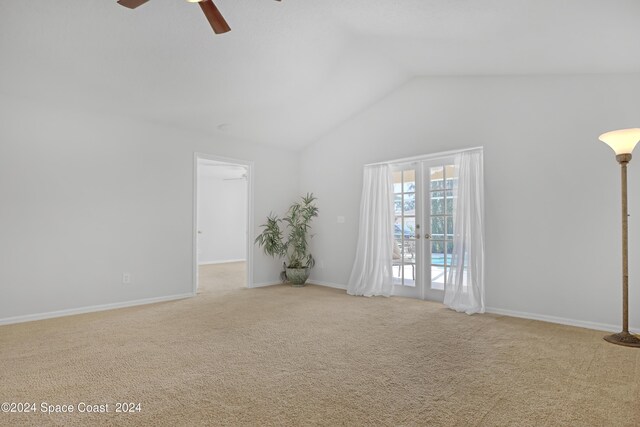 unfurnished room featuring light carpet, lofted ceiling, and ceiling fan