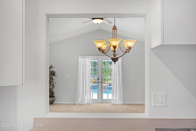 details with ceiling fan with notable chandelier, carpet flooring, and french doors