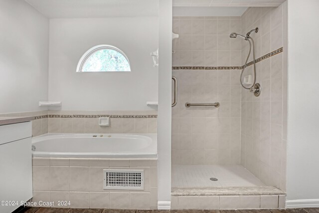 bathroom with vanity and plus walk in shower